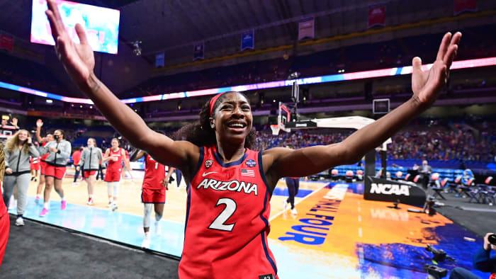 Aari McDonald throws up her arms in celebration after beating UConn